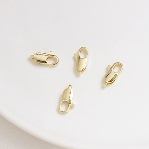 Close-up of four polished 14K gold plated lobster clasps for DIY jewelry making