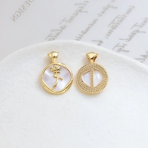 Detailed view of vintage gold plated rose pendant and hollow shell charms for DIY jewelry