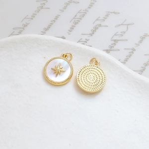 Detail showing shell inlay pendant with gold star motif and textured metal back