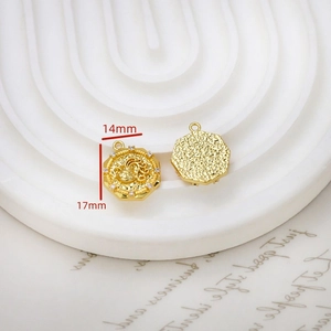 Macro shot of 14x17mm gold Aquarius coin pendant with cubic zirconia and hammered edges