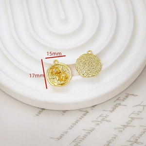 Macro view of 15mm gold-plated floral relief pendant with embossed flower patterns