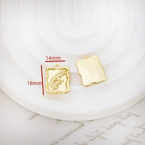 Detailed view of rectangle gold plated leaf pendants with wavy edges and dimensions
