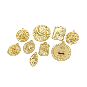 Set of 10 vintage gold plated charms with embossed floral motifs and zircon stones