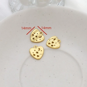 Macro shot of 14mm heart-shaped gold-plated pendants with hollow star and moon patterns