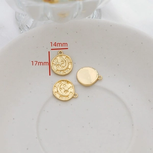 Detailed view of gold-plated sun and moon pendant with 14mm diameter and embossed patterns