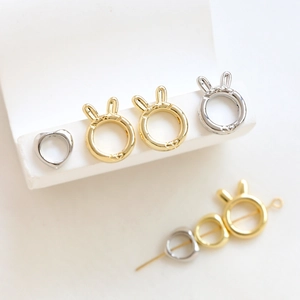Polished gold and silver bunny ear beads and heart rings for DIY jewelry making