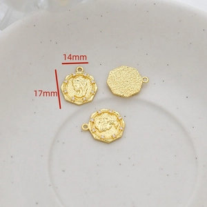 Detail of 14mm and 17mm gold octagonal coin charms with embossed profile and white stones