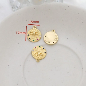 Detail of vintage gold-plated eye charms with colorful gemstones and size markings