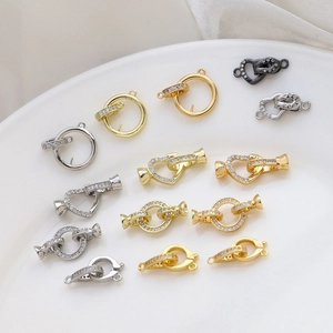 Gold plated zircon connectors and lobster clasps for DIY jewelry making on ceramic plate