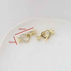 Macro shot of gold-plated heart clasp with cubic zirconia for DIY jewelry making 24x10mm