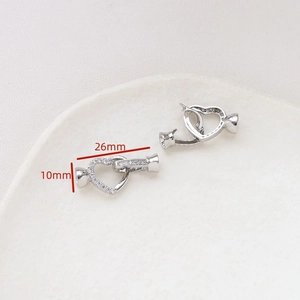 Macro detail of heart-shaped jewelry clasp with cubic zirconia measuring 26mm by 10mm