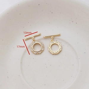Detailed macro view of 17mm gold OT toggle clasp with cubic zirconia heart and star accents