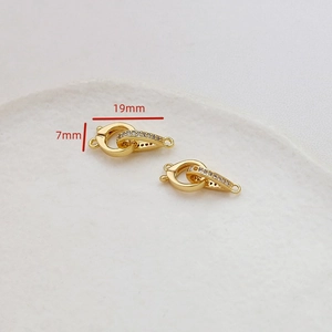 Macro detail of 19mm gold plated jewelry connector clasp with inlaid cubic zirconia
