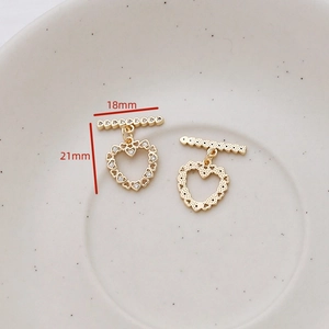 Detailed view of heart-shaped gold-plated OT toggle clasps with cubic zirconia inlay