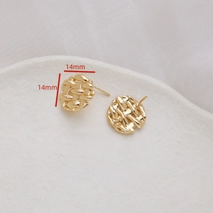 Detail view of 14mm round vintage braided gold earrings with cubic zirconia inlay