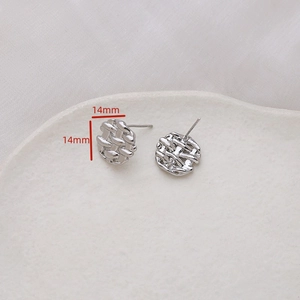 Macro view of 14mm silver round disc earrings with intricate woven texture and s925 silver pins