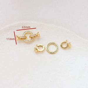 Macro view of gold-plated copper connector clasp with zircon inlay and size dimensions