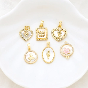 Gold plated heart and butterfly charms with mother of pearl inlays for jewelry making