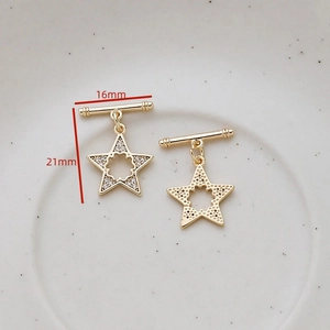 Macro detail of gold star OT toggle clasp set with CZ stones measuring 16mm by 21mm