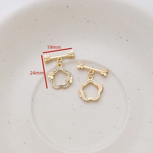 Macro view of gold plated flower toggle clasp with zircon butterfly for DIY jewelry