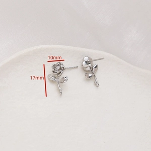 Detailed view of silver rose earrings with cubic zirconia and 10x17mm size markings