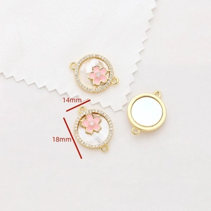 Detail of 14mm gold-plated cherry blossom pendant with pink enamel and shell inlay