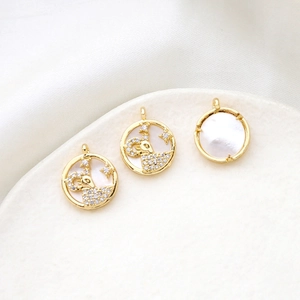Detailed view of 18k gold-plated Aries zodiac pendant with white mother of pearl and zircons