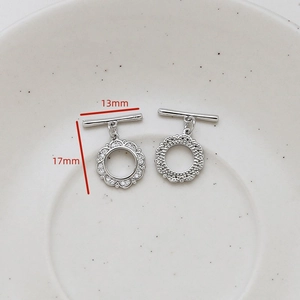 Macro shot of silver flower-shaped OT toggle clasps with cubic zirconia and dimensions