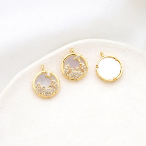 Detailed view of Cancer zodiac shell pendant with gold plating and zircon inlay