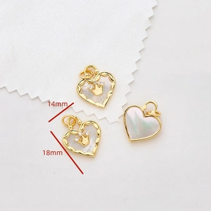 Detailed view of 18x14mm gold-plated heart pendant with white mother of pearl and crown