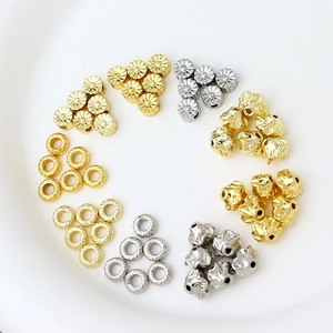 Floral and irregular gold-plated spacer beads arranged in a circle for DIY jewelry