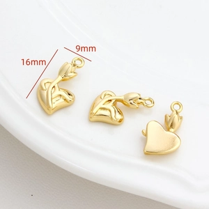 Macro detail of tulip flower heart pendant in gold finish for DIY jewelry 16mm x 9mm
