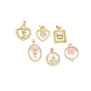 Gold-plated heart and butterfly charms with zircron and mother of pearl insets