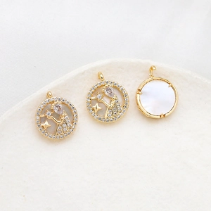 Detailed view of gold plated zodiac pendant with mother of pearl and sparkling zircons