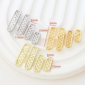 Detail of 14k gold plated hollow rhombus jewelry spacers with side-set cubic zirconia