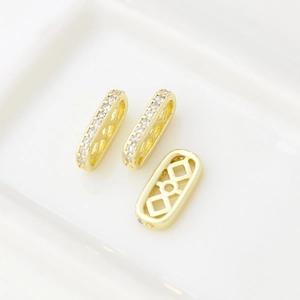Detailed view of hollowed-out 18k gold plated spacer beads with inlaid zircons for DIY jewelry