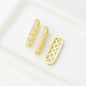 Macro detail of 18k gold plated square spacer beads with cubic zirconia for DIY jewelry