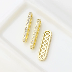 Macro shot of 14k gold plated square spacer beads with zircon inlay for jewelry making