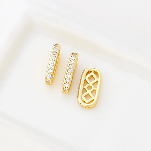 Macro detail of 14k gold plated square spacer beads with sparkling zircon stones