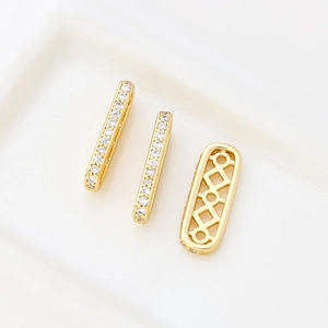 Macro detail of 14k gold plated square spacer beads with zircon inlays for DIY jewelry