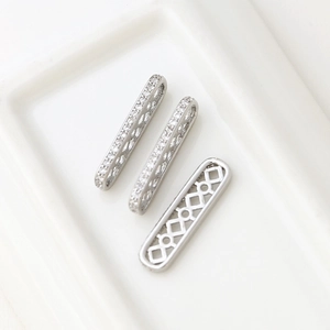 Macro view of micro-pave cubic zirconia rectangular spacers with hollow geometric patterns
