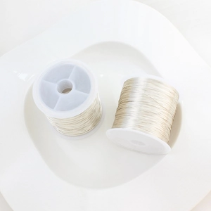 Detail of 14K gold filled jewelry wire on white spools for DIY craft and wire wrapping