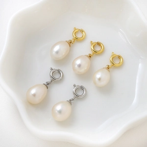 DIY 18K freshwater pearl pendants with gold and silver spring clasps on ceramic tray