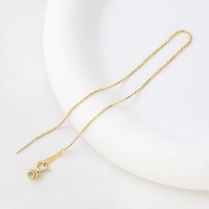 Detail view of gold box chain with spring clasp and adjustable needle pin end