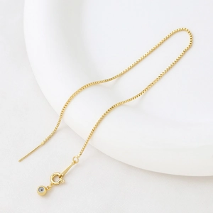 Detail view of a 14k gold plated adjustable box chain with spring clasp and needle end