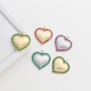 Detailed view of heart charms with colorful zircon inlay for DIY jewelry making