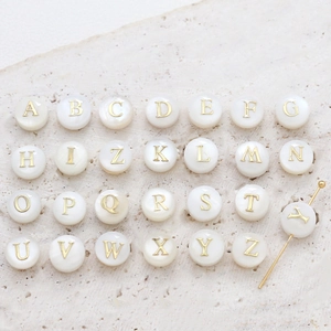 Natural shell round letter beads with gold initials and central hole for DIY jewelry