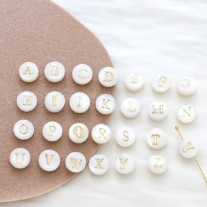 Round white shell alphabet beads with gold letters for custom DIY jewelry making