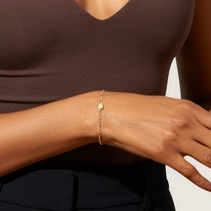 Elegant gold Figaro chain bracelet with a green aventurine gemstone charm for women