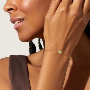 Elegant gold chain bracelet featuring a round light green aventurine gemstone for women